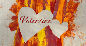 the word Valentine in two heart with paint around the hearts
